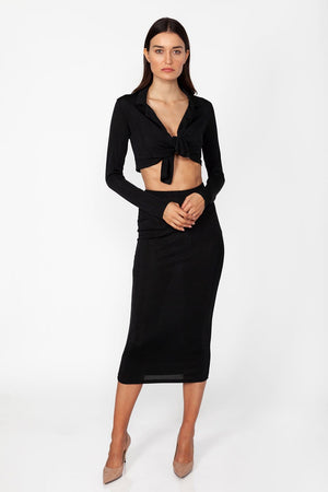 Miss Sunset Set - Model wearing set of top and skirt in black color with long sleeves and crop top, posing for front view