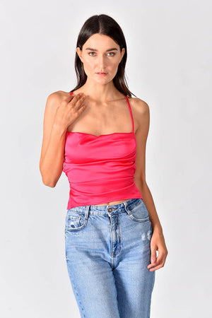 Ivy Top - Model is posing while wearing a trendy silky straight-cut top, in pink color.