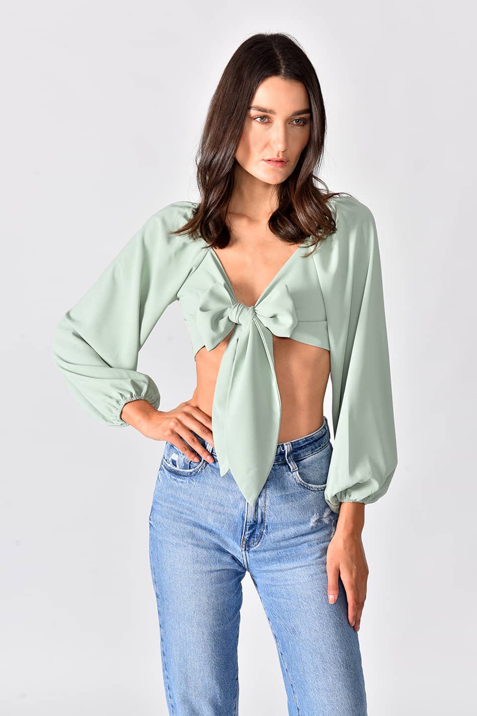 Model in pose for front view while wearing trendy crop top in green color