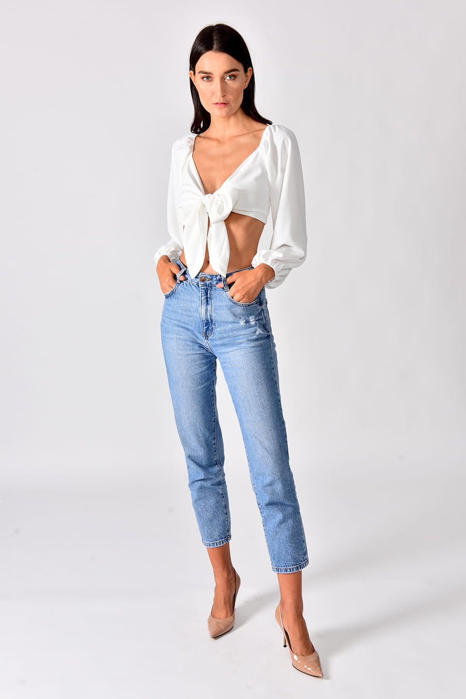 Model in pose for full-body view, while wearing trendy crop top in white color