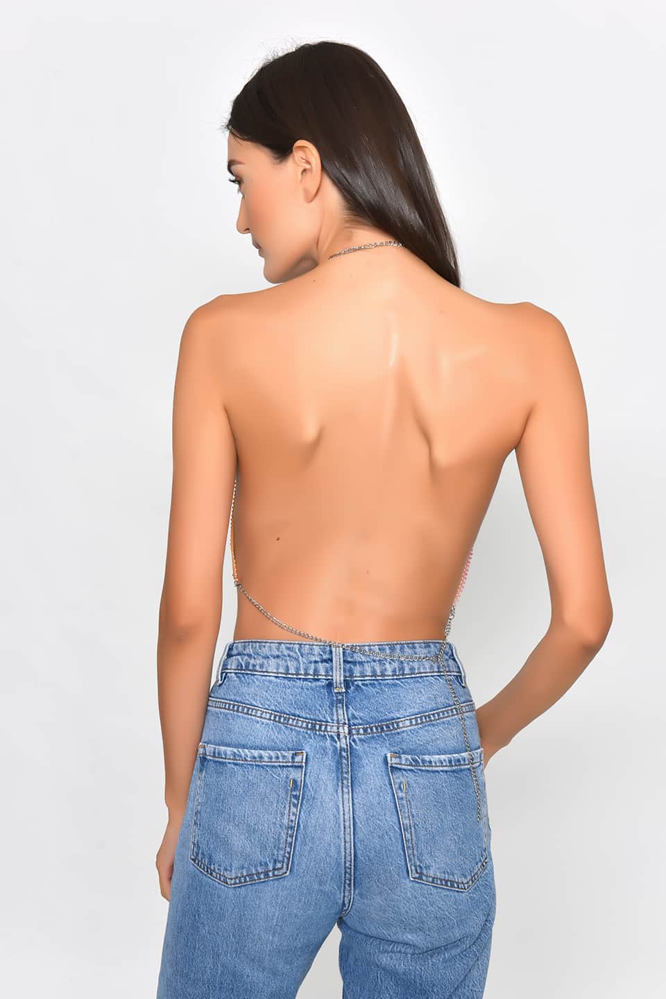 Model in pose for back view is wearing shiny crop top in pink-yellow gradient color.