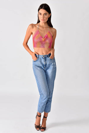 Sparkly Top Pink - Model in full-body pose is wearing shiny crop top in pink-yellow gradient color.