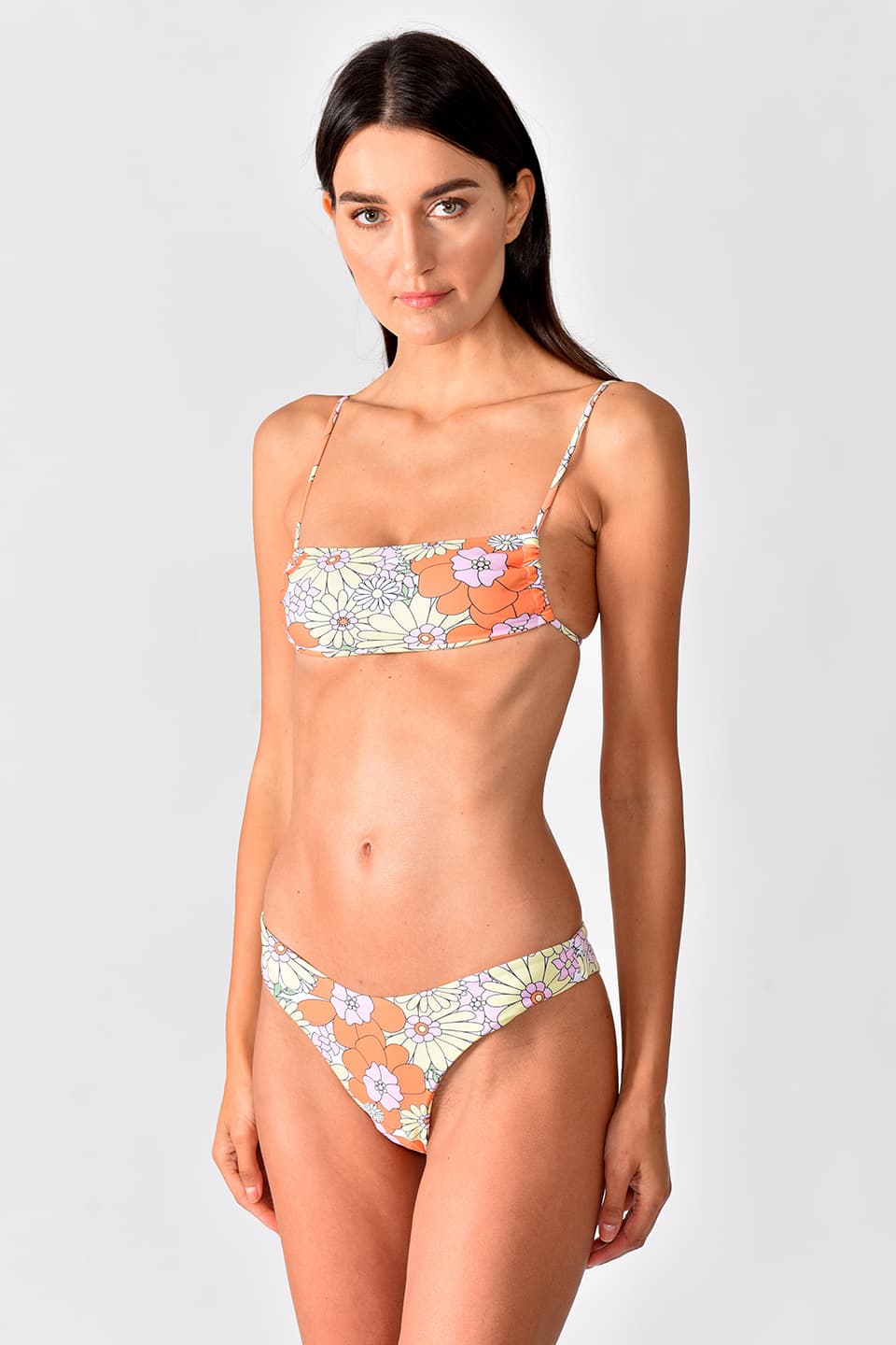 Colorful Bikini with flower pattern with flat top and adjustable string ties, is wore by model in pose