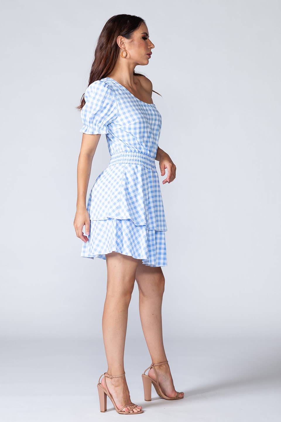 Blue flamenco, one shoulder mini dress in light blue and white, model posing for side view