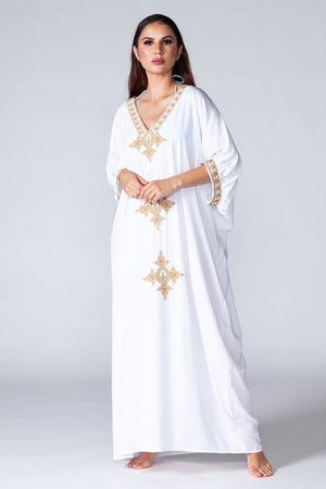 Casablanca Kaftan - Mid sleeve white kaftan with golden details, model posing for front view