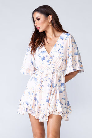 Dancing Queen Dress - Whitish floral ruffled summer mini dress with V-neck and short sleeves. Model natural posing