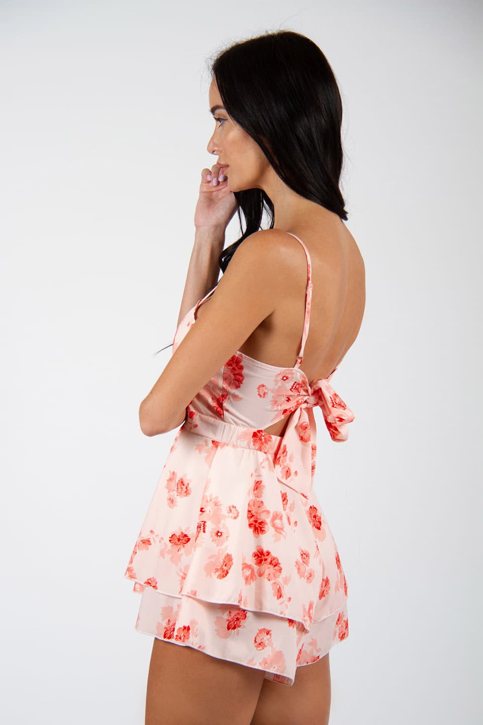 New floral print playsuit, in white and red colors. Model posing for back view