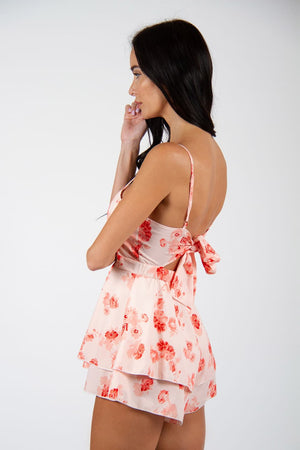 Fierce Playsuit - New floral print playsuit, in white and red colors. Model posing for back view