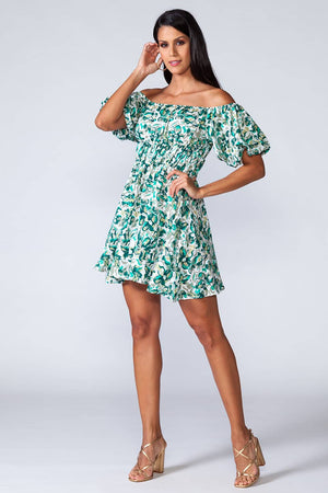 Flora Dress - Off-shoulder mini dress with elastic waist and ruffled bottom of the skirt. Model natural posing