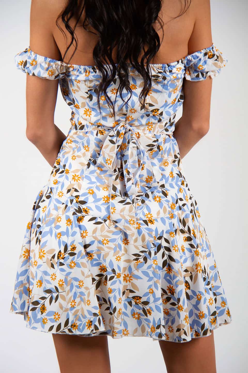 Trendy and colorful floral print mini dress with belt. Back details