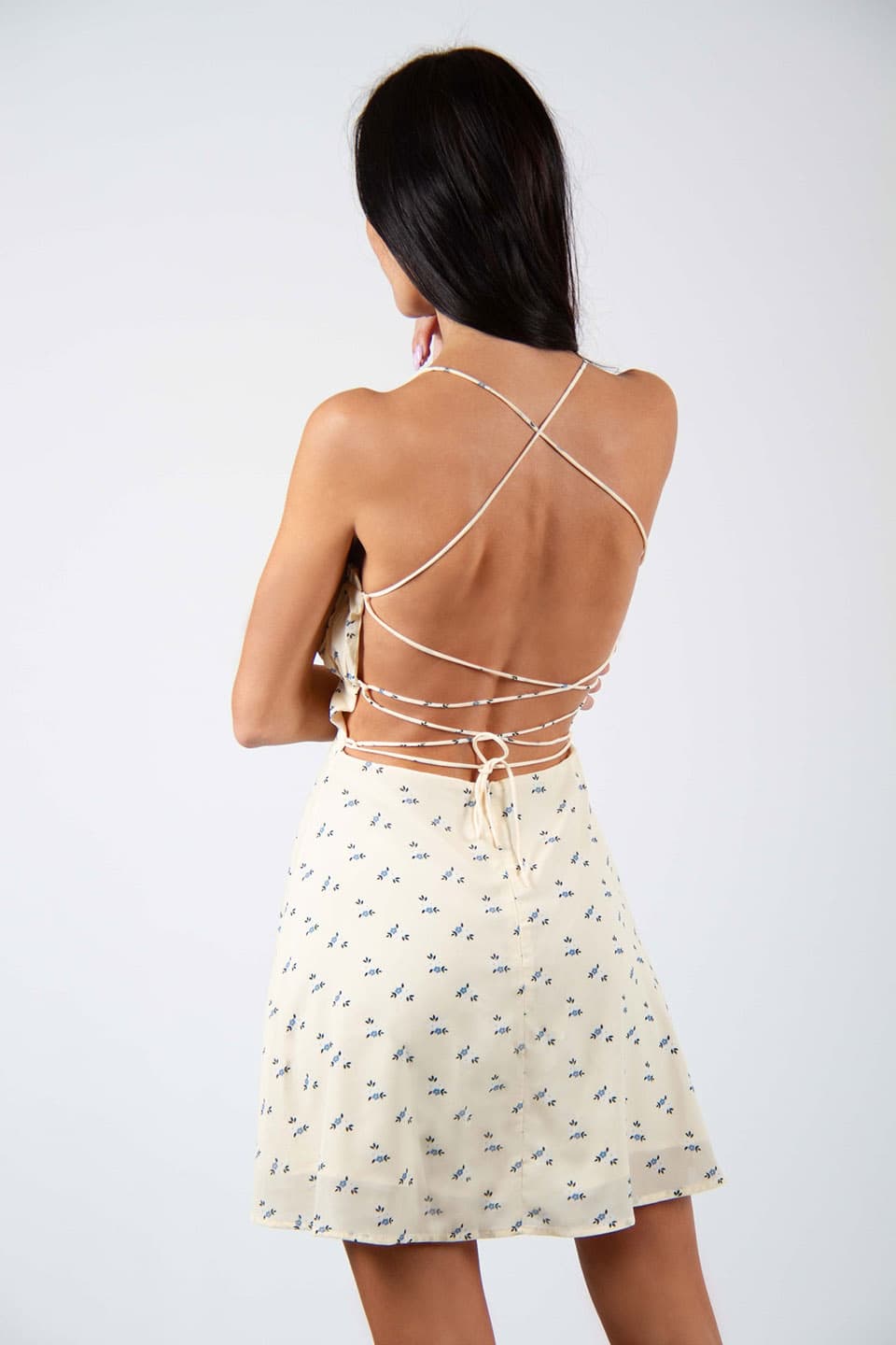 Flower printed and open back mini dress. Model wearing Gentle Soul Dress, posing for back view