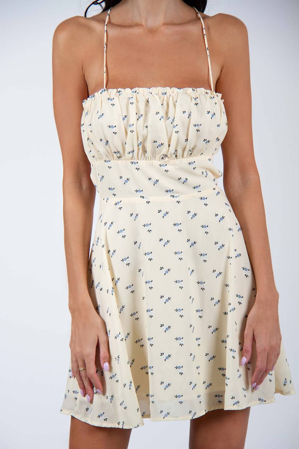 Flower printed and open back mini dress. Model wearing Gentle Soul Dress, texture details