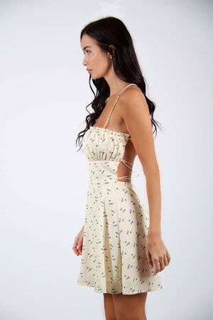 Gentle Soul Dress - Flower printed and open back mini dress. Model wearing Gentle Soul Dress, posing on side