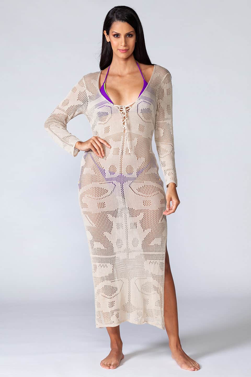 Knitted hollowed-out kaftan with long sleeves and ties in the front. Model posing in front