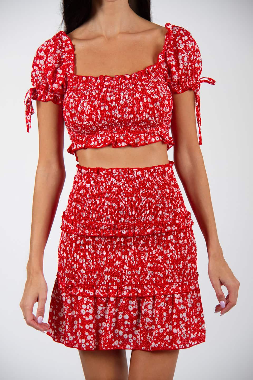 Model wearing flower print skirt and stretchable top. Shoulders details