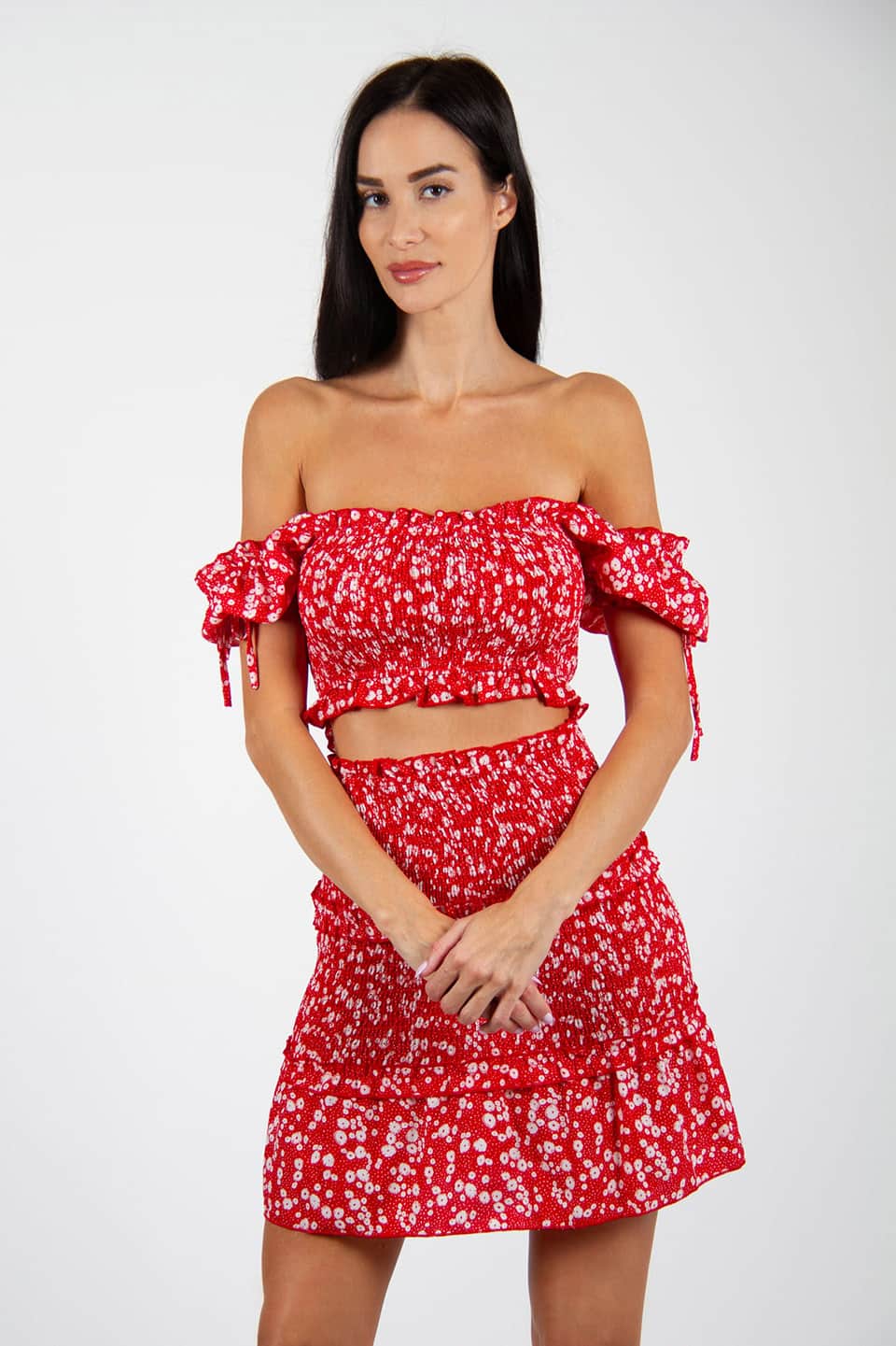 Model in natural pose wearing flower print skirt and stretchable top.