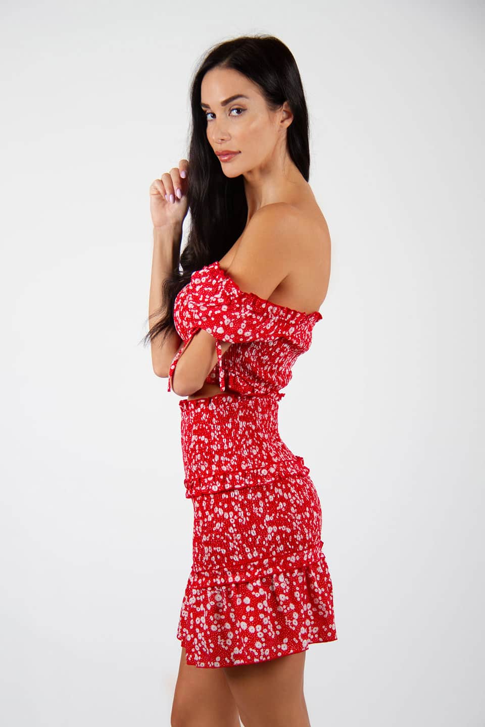 Model wearing flower print skirt and stretchable top. Side view