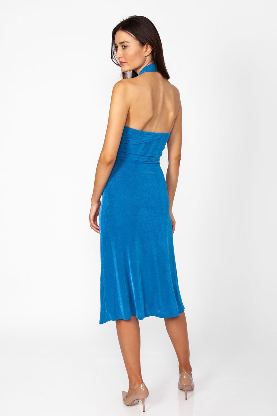 Model wearing stretchable midi dress in blue color with open back. Back view