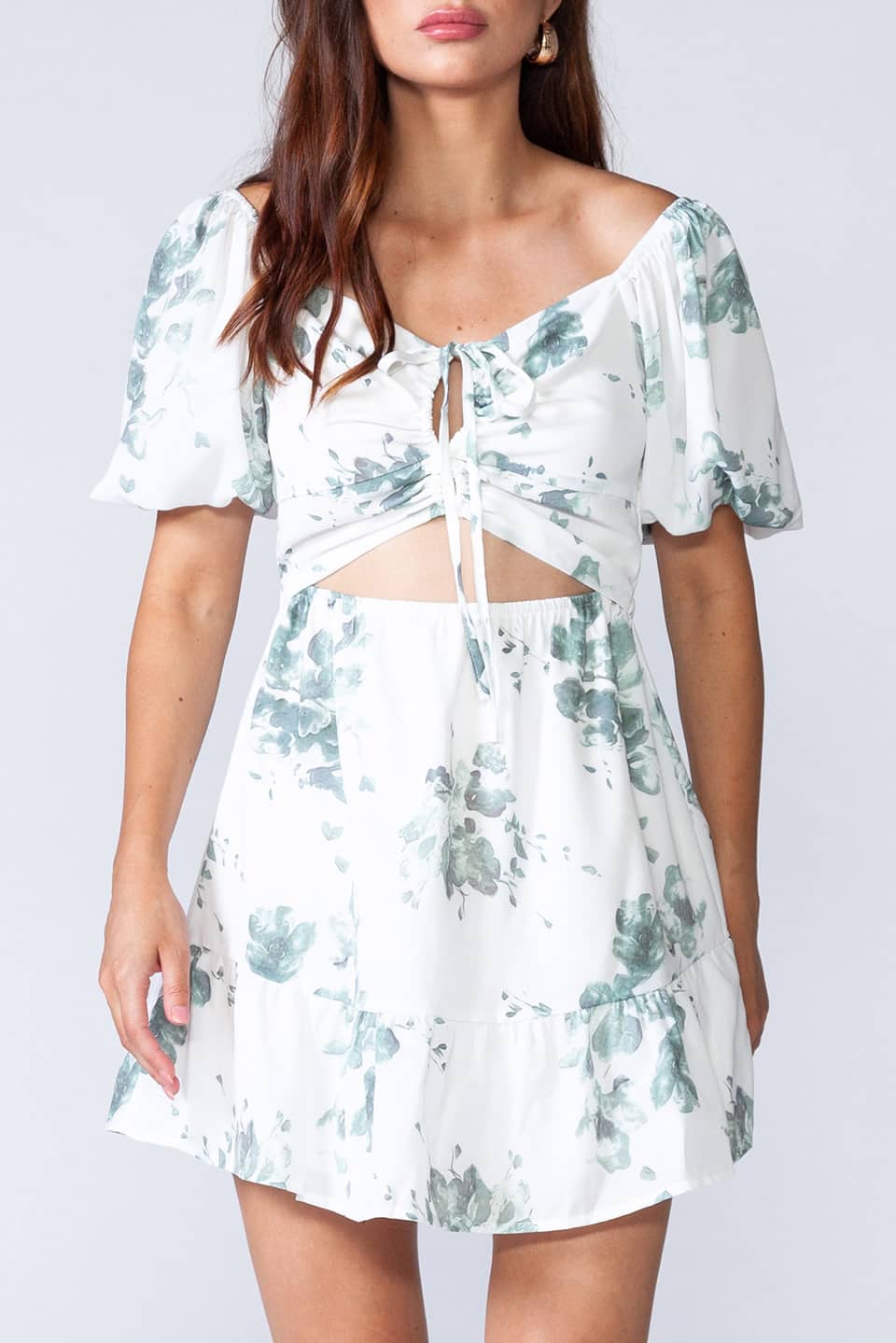 White mini dress with floral print, puff sleeves and cut-out front. Texture details