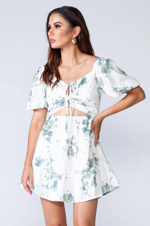 Mojito Dress - White mini dress with floral print, puff sleeves and cut-out front. Model shows cloth details