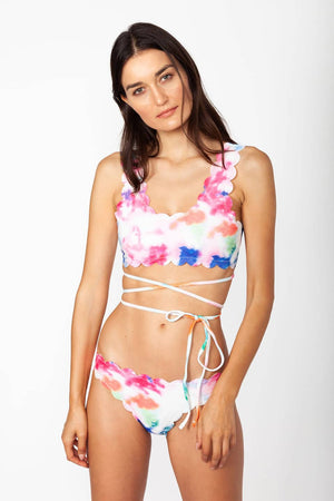 Mykonos flower bikini - Model wears multicolor two-piece swimwear with self-tie straps around the waist, posing for front view.