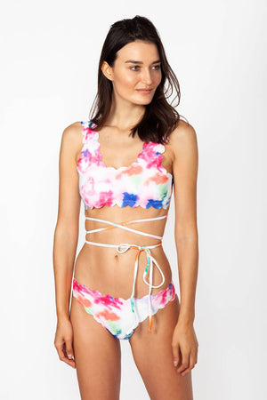 Mykonos flower bikini - Model wears multicolor two-piece swimwear with self-tie straps around the waist, in a natural pose