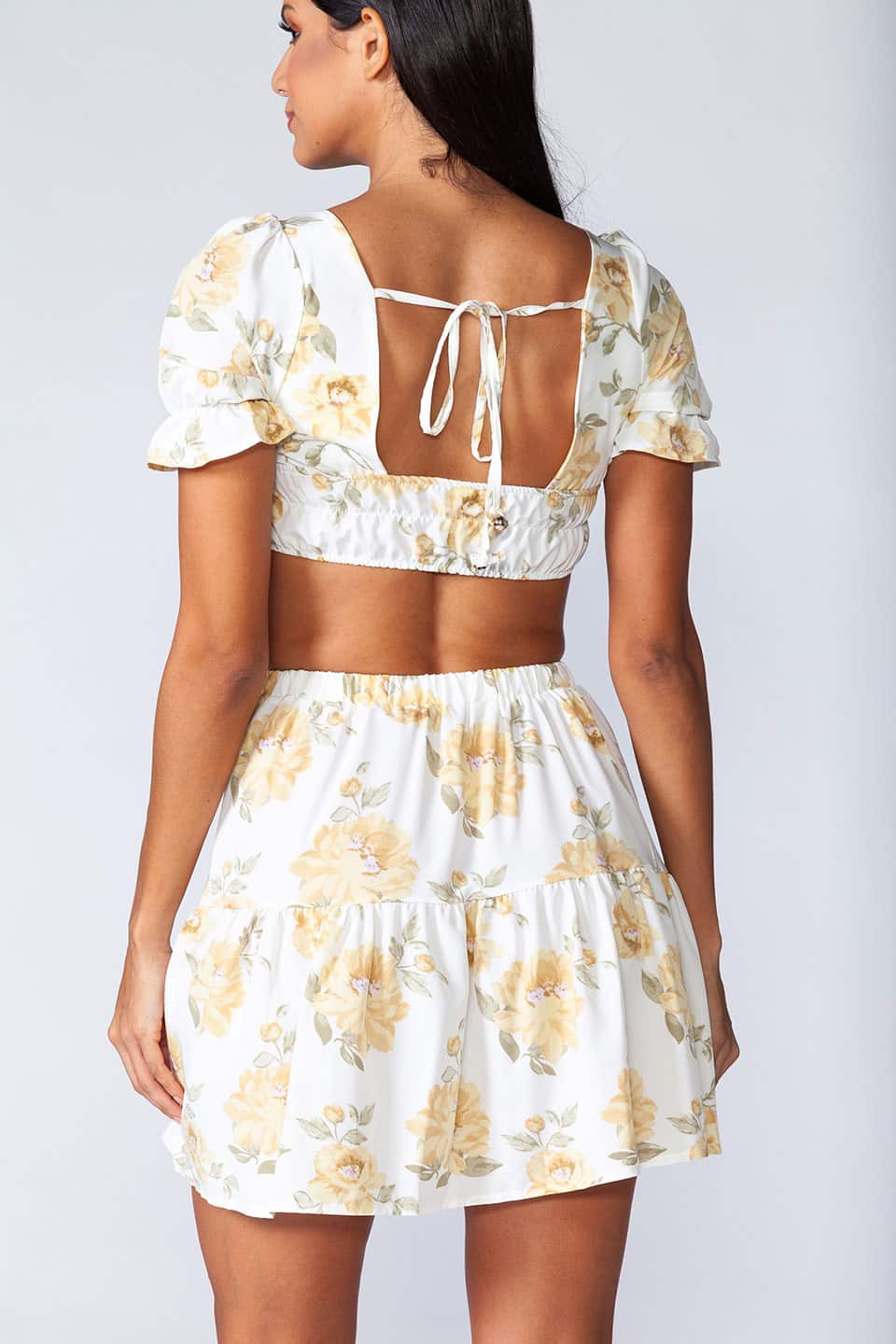 Model wearing trendy two piece set with floral print, back tie details