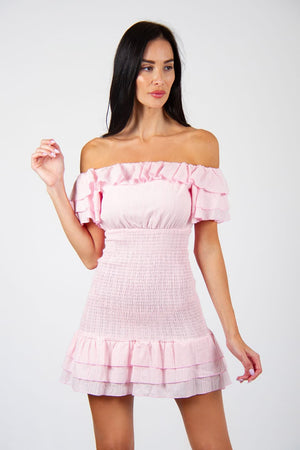 Pinky Dress - Model wears trendy off-shoulder elasticated pink mini dress, posing for front view