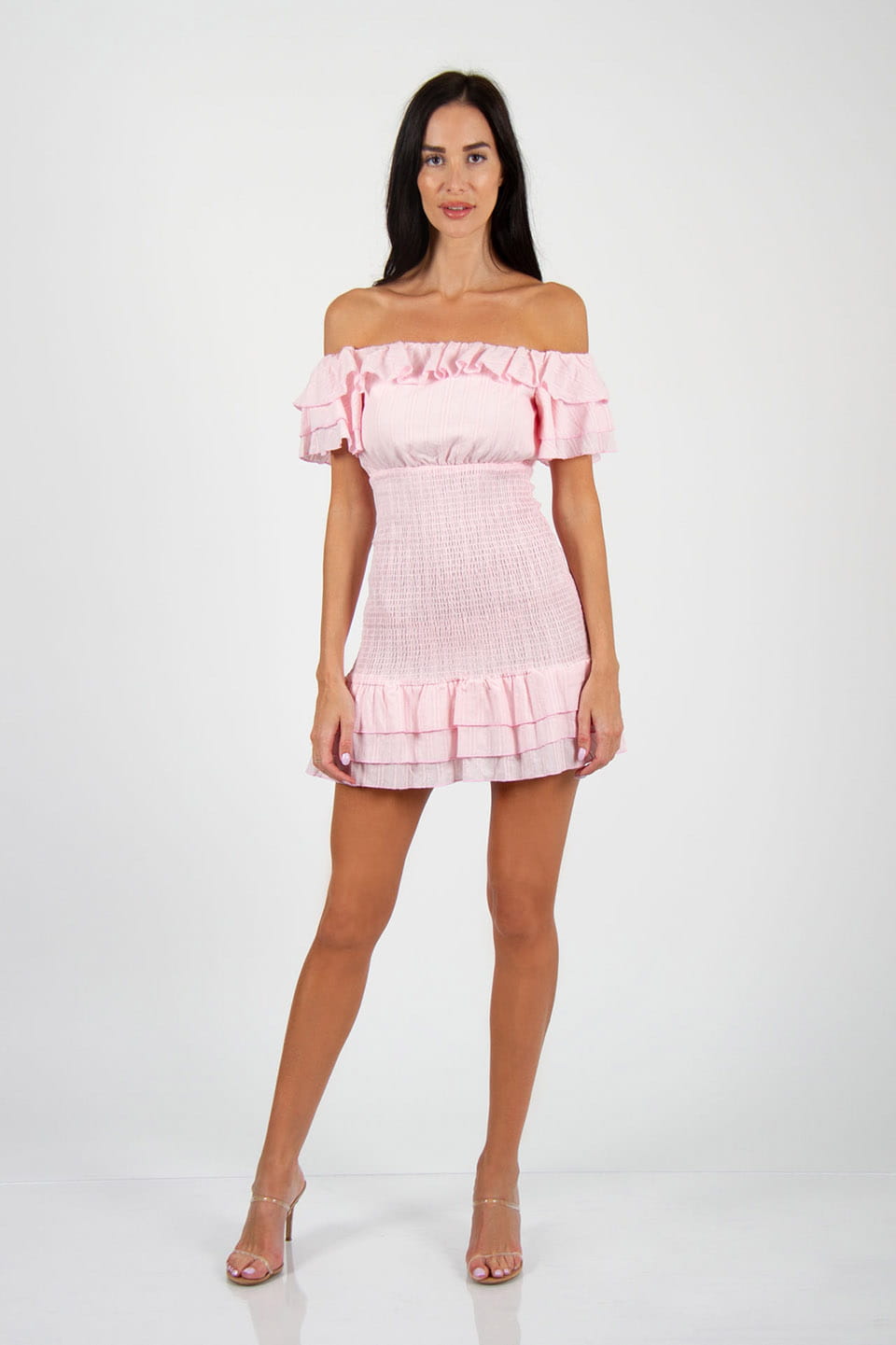 Model wears trendy off-shoulder elasticated pink mini dress, full body view