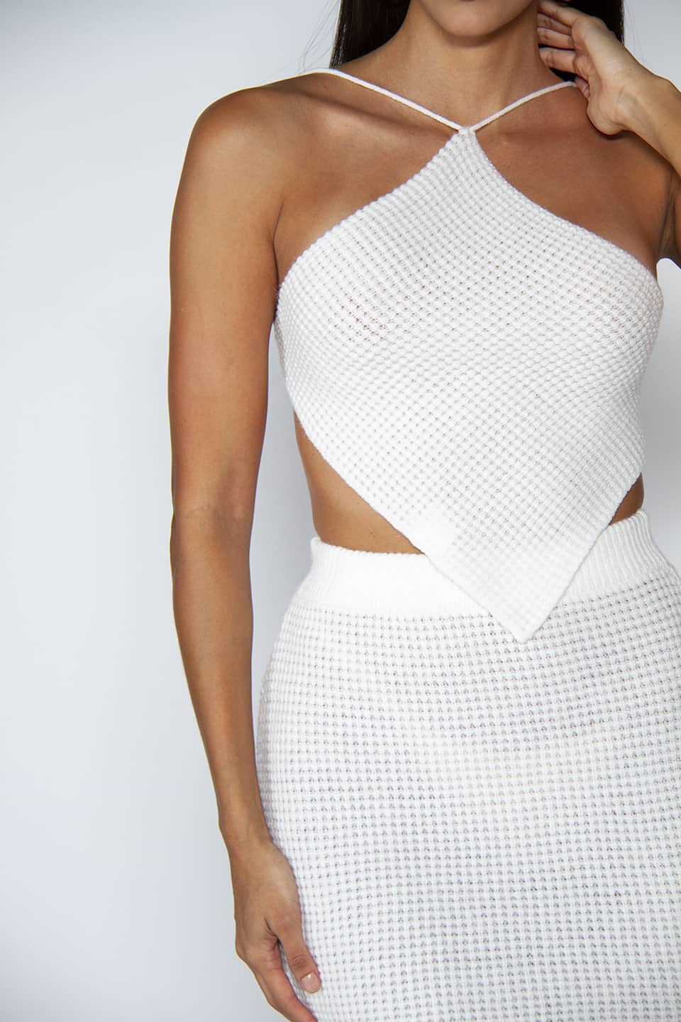 Retro style knitted top and skirt in white color. Front texture details