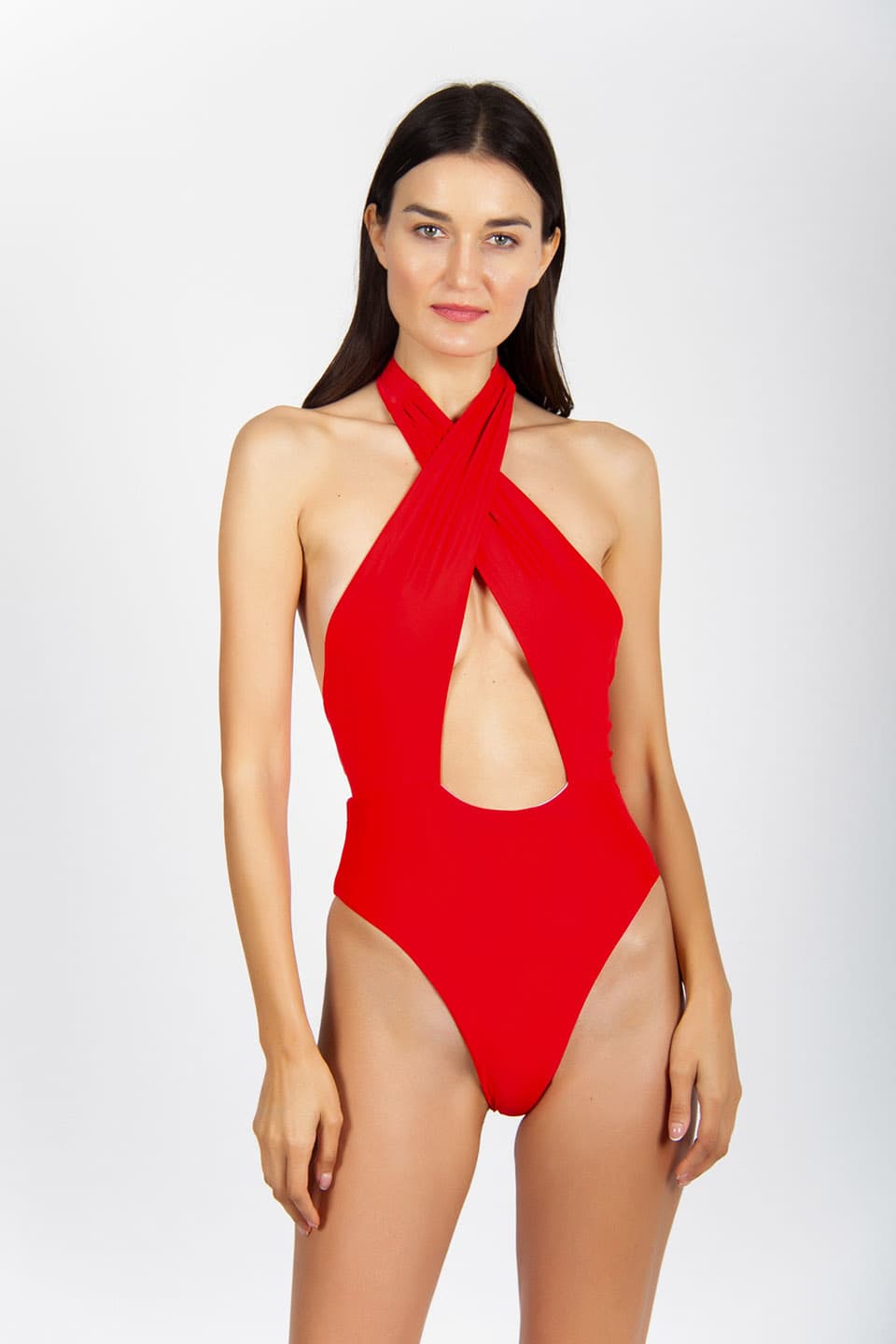 Model wearing red one-piece swimsuit, tied around the neck. Front view