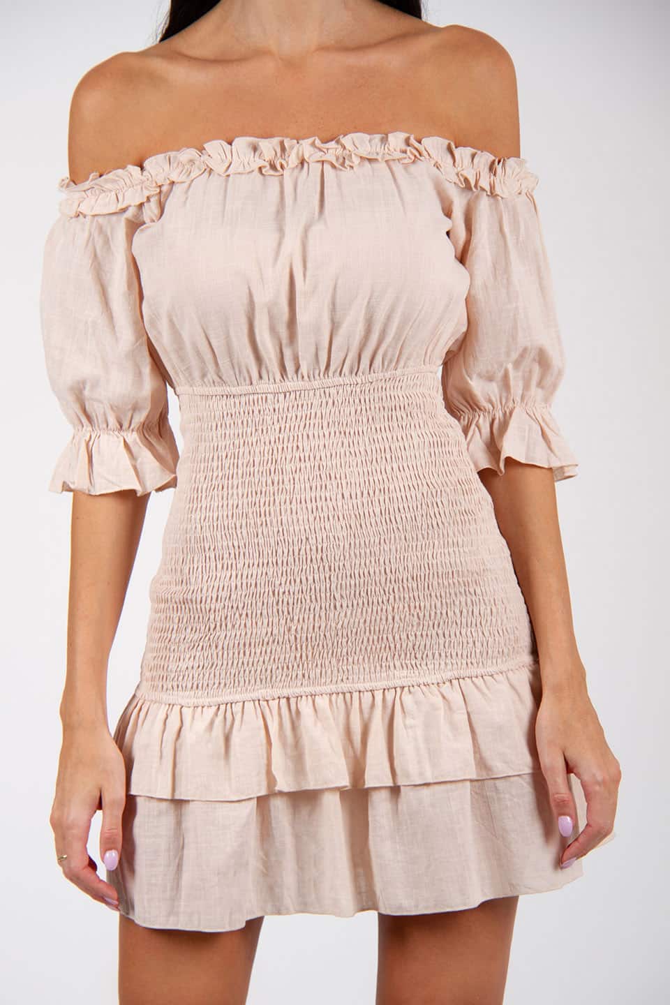 Model wearing off-shoulder mini dress with a linen texture. Zoom on material