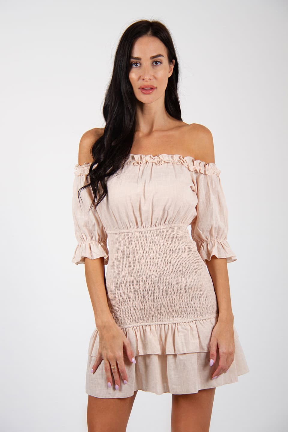 Model wearing off-shoulder mini dress with a linen texture. Front view