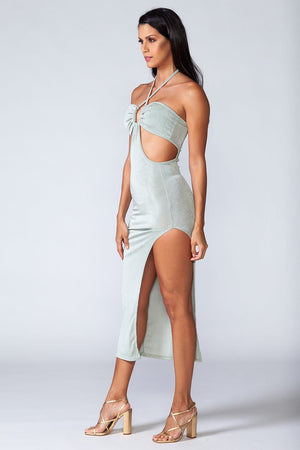 Señorita Dress - Model wears trendy turquoise midi dress with high slit on the side, posing on left side
