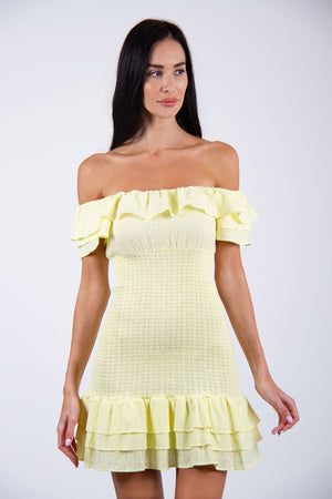 Sunshine Dress - Model wears off-shoulder elasticated dress in yellow color, posing for front view