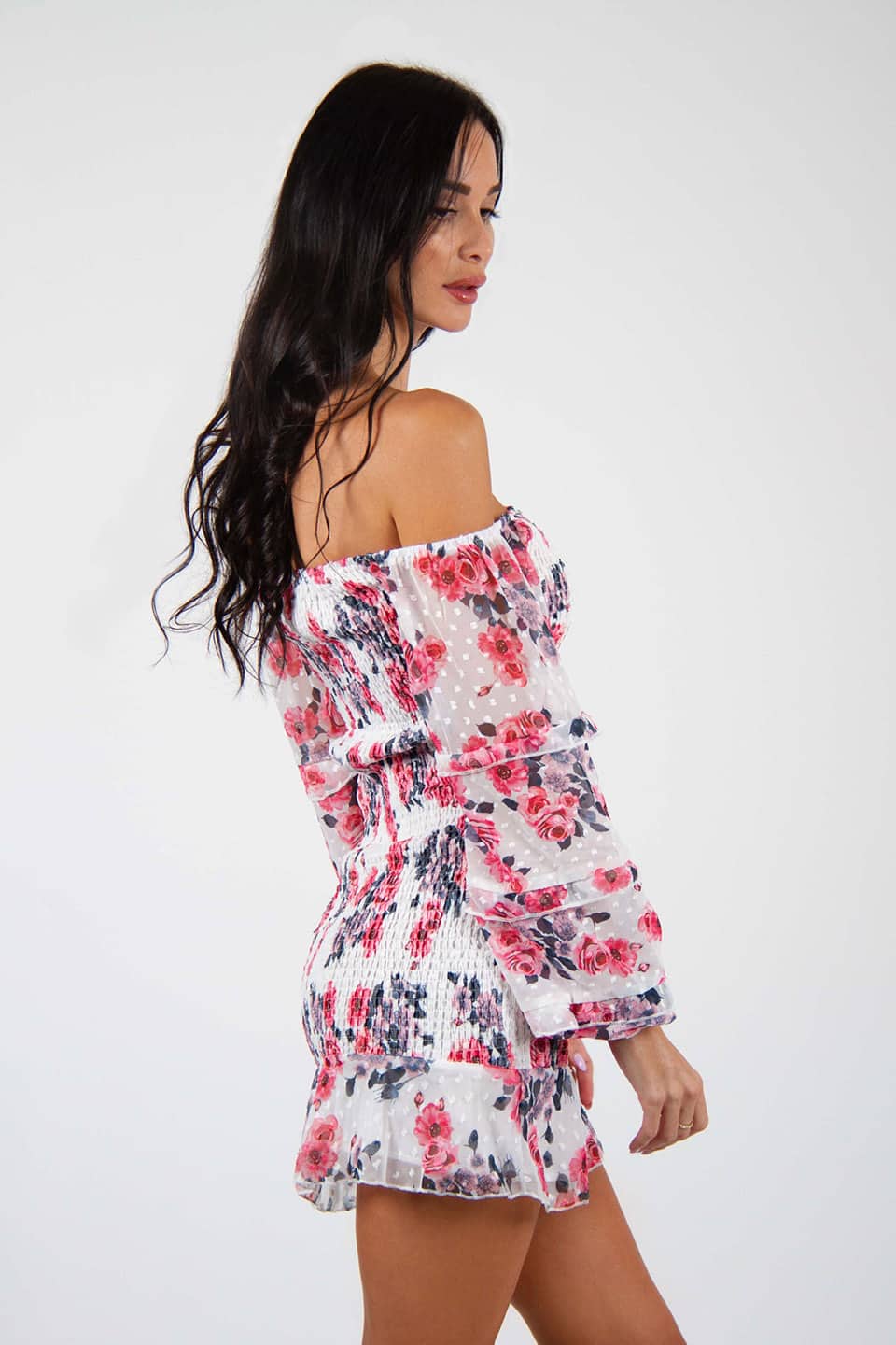 Model wearing off-shoulder floral print bodycon mini dress with long puff sleeves, posing on side view
