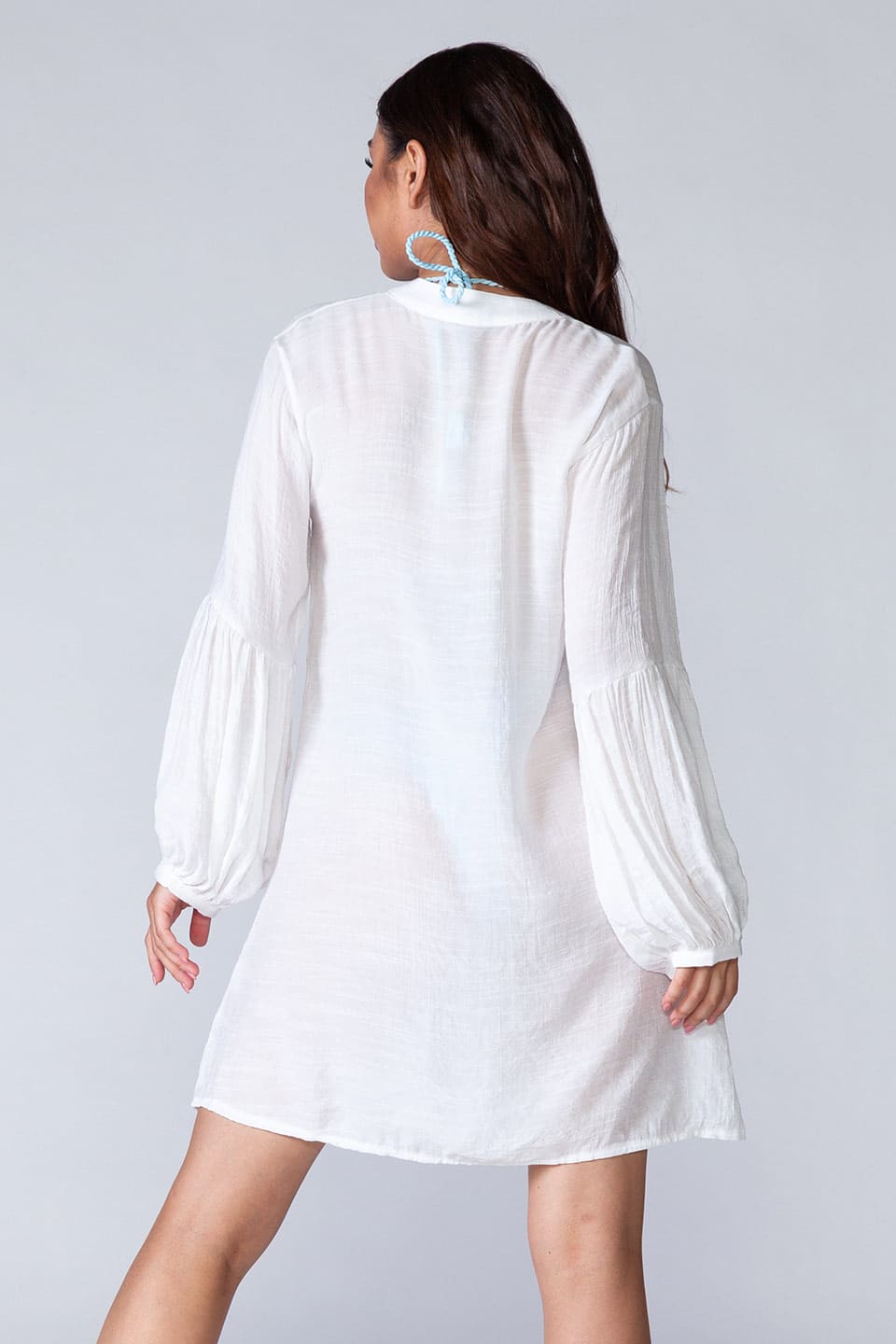 Model wearing long sleeved beach shirt kaftan style, back view
